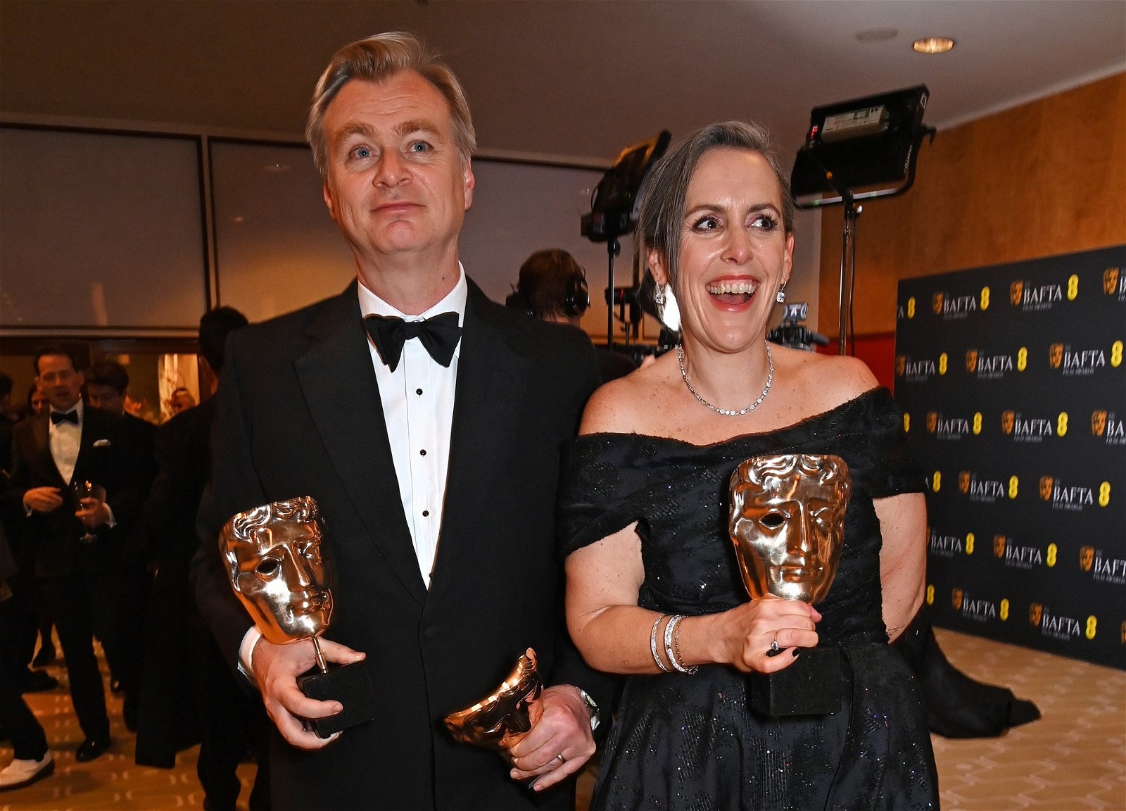 Christopher Nolan and Emma Thompson hold BAFTA trophies