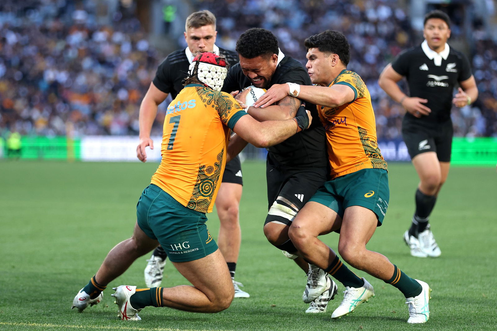 Ardie Savea tackled by the Wallabies.