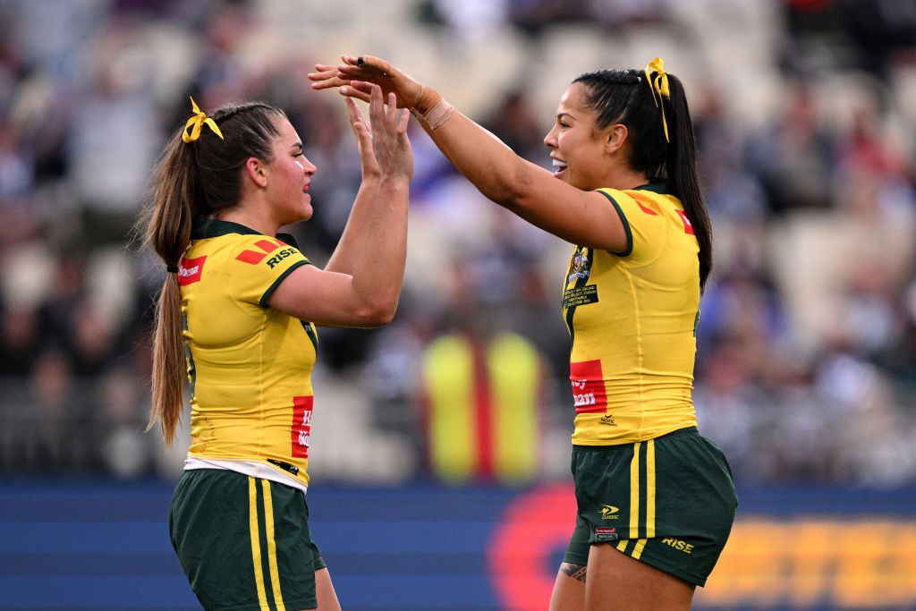 Jakiya Whitfeld and Tiana Penitani high-10 in a rugby league Test.