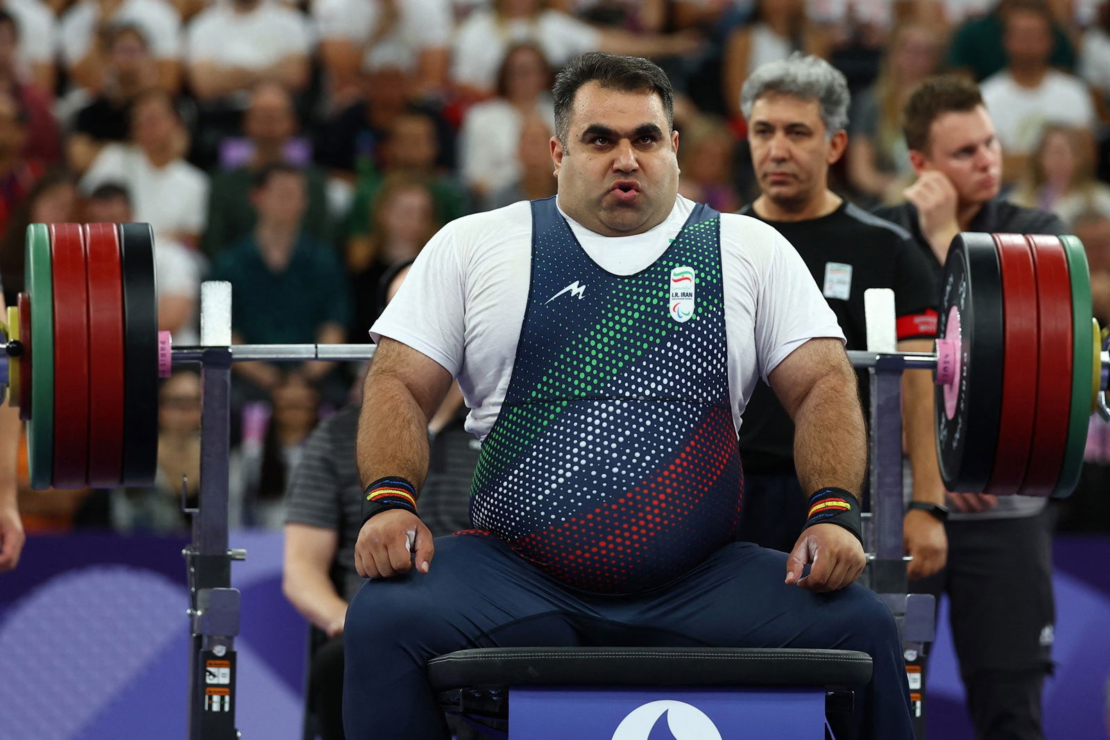 Ahmad Aminzadeh of Iran prepares to lift, sitting on the bench