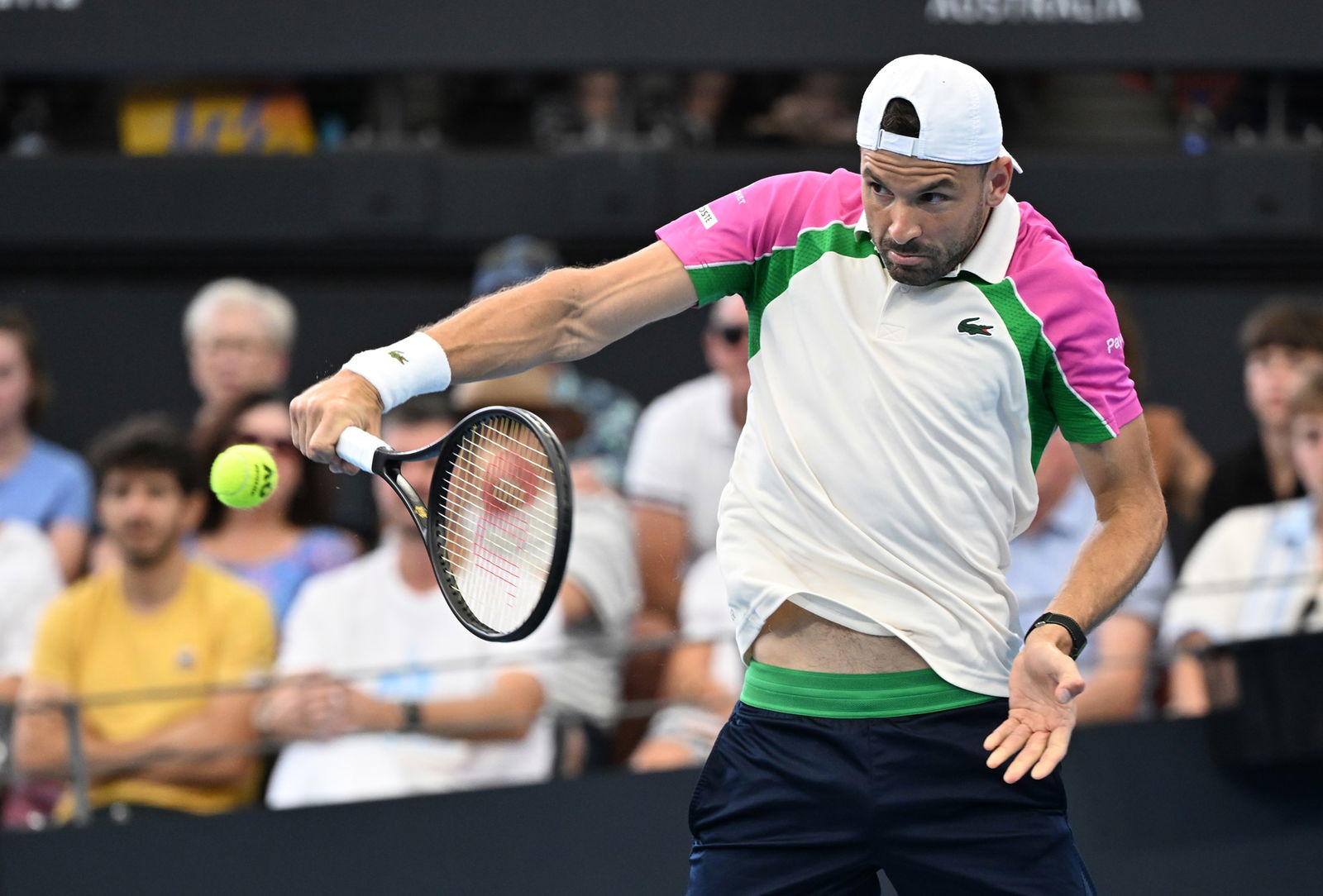 Grigor Dimitrov plays a backhand.