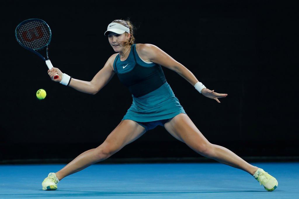 Mirra Andreeva slides into a forehand at the Australian Open.