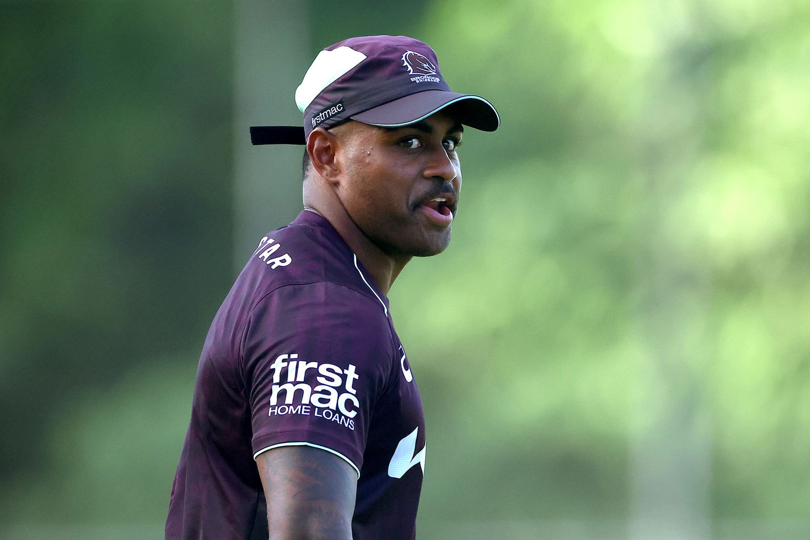 Ezra Mam participates in NRL Broncos training, looking over his right shoulder