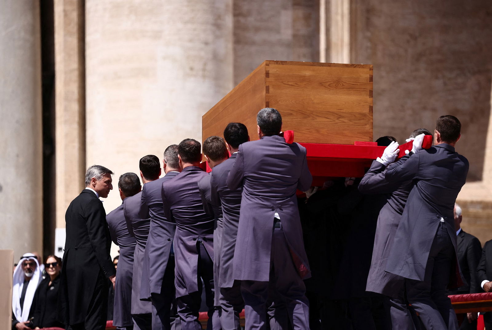 Pallbearers carrying a coffin.