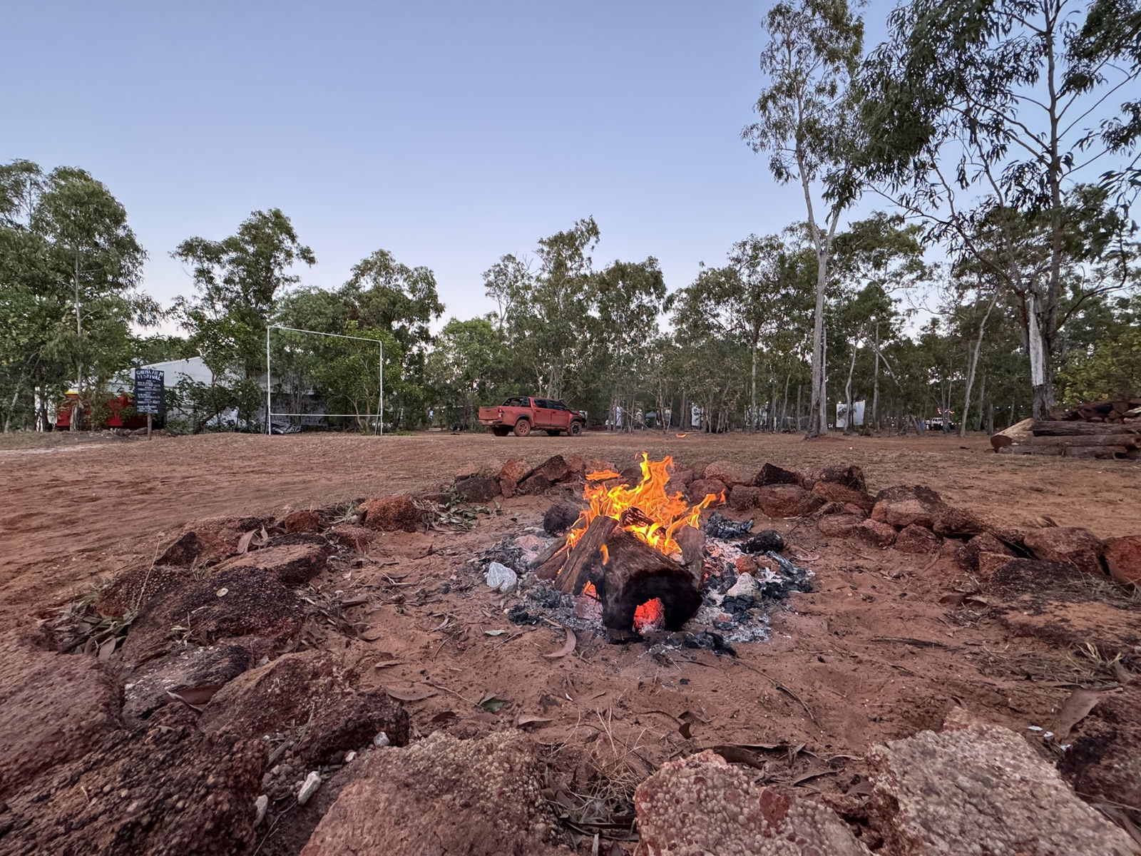 A fire burns in a bush landscape.