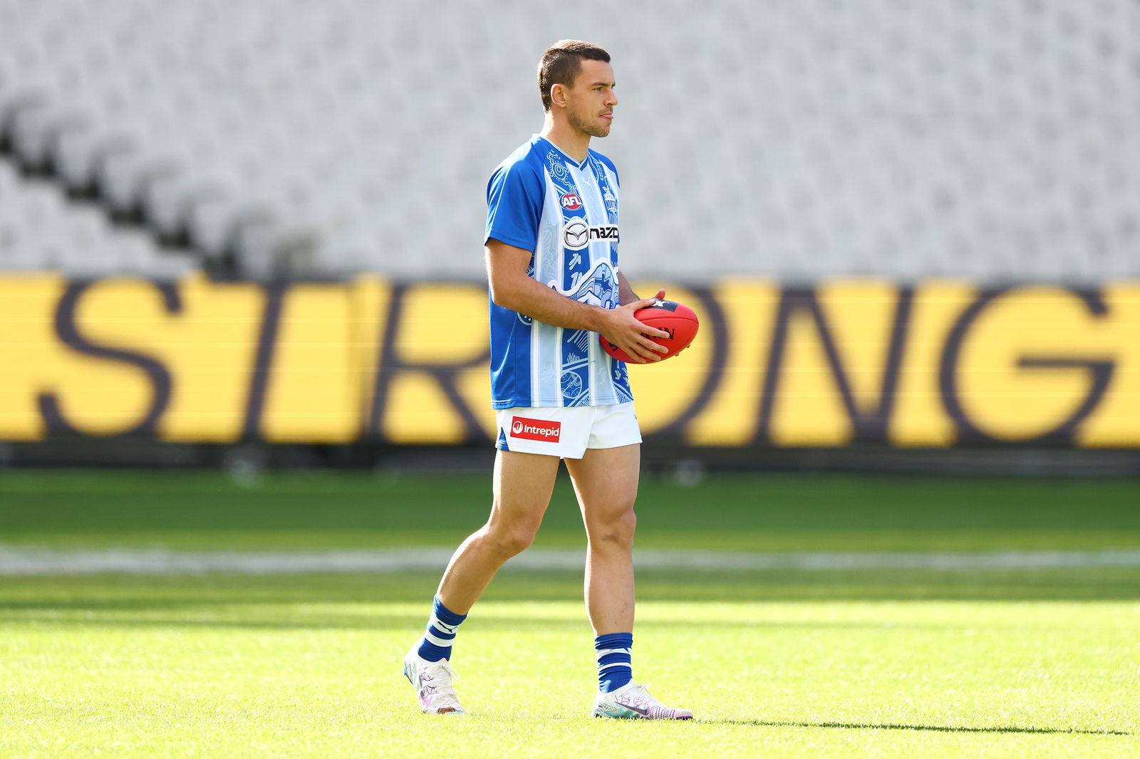 Luke Davies-Uniacke of the Kangaroos warms up ahead of the round ten AFL match between Richmond Tigers and North Melbourne Kangaroos at Melbourne Cricket Ground, on May 18, 2025, in Melbourne, Australia.