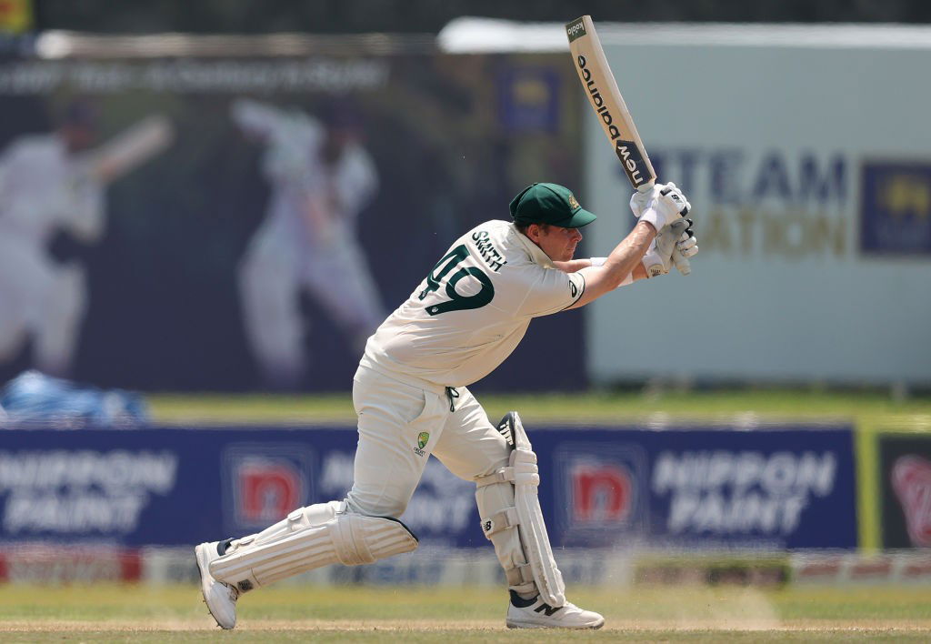 Steve Smith plays a shot on a dusty pitch.