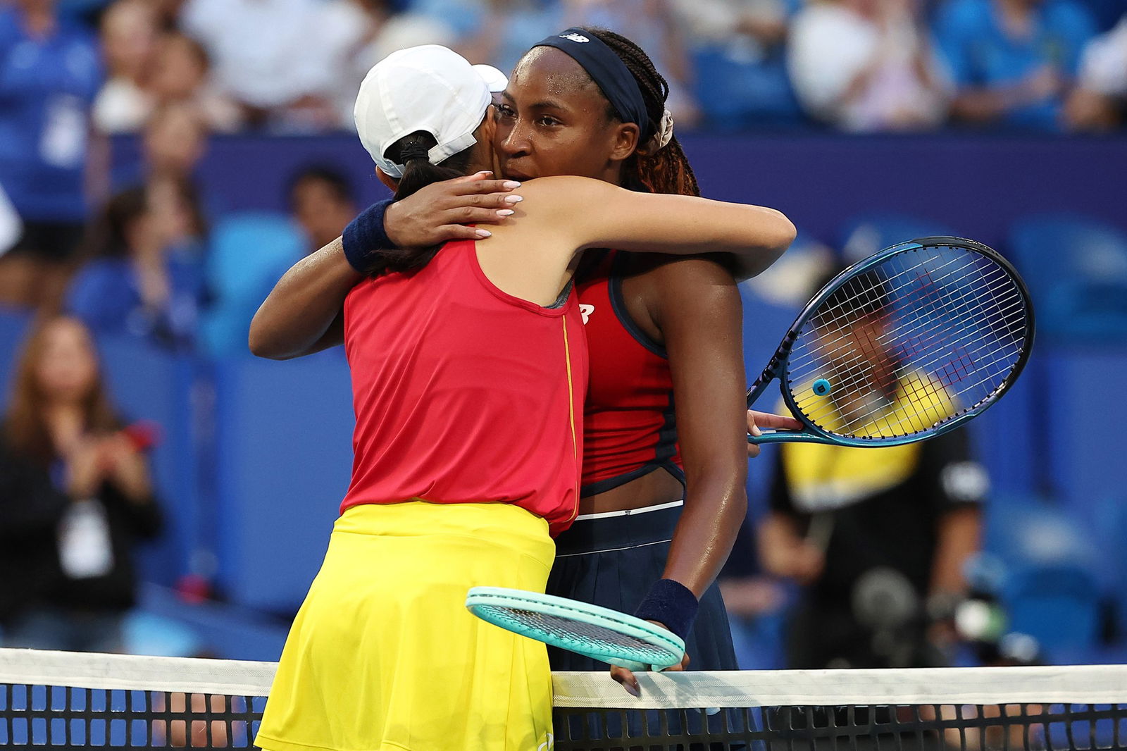 Coco Gauff hugs Zhang Shuai at the net.