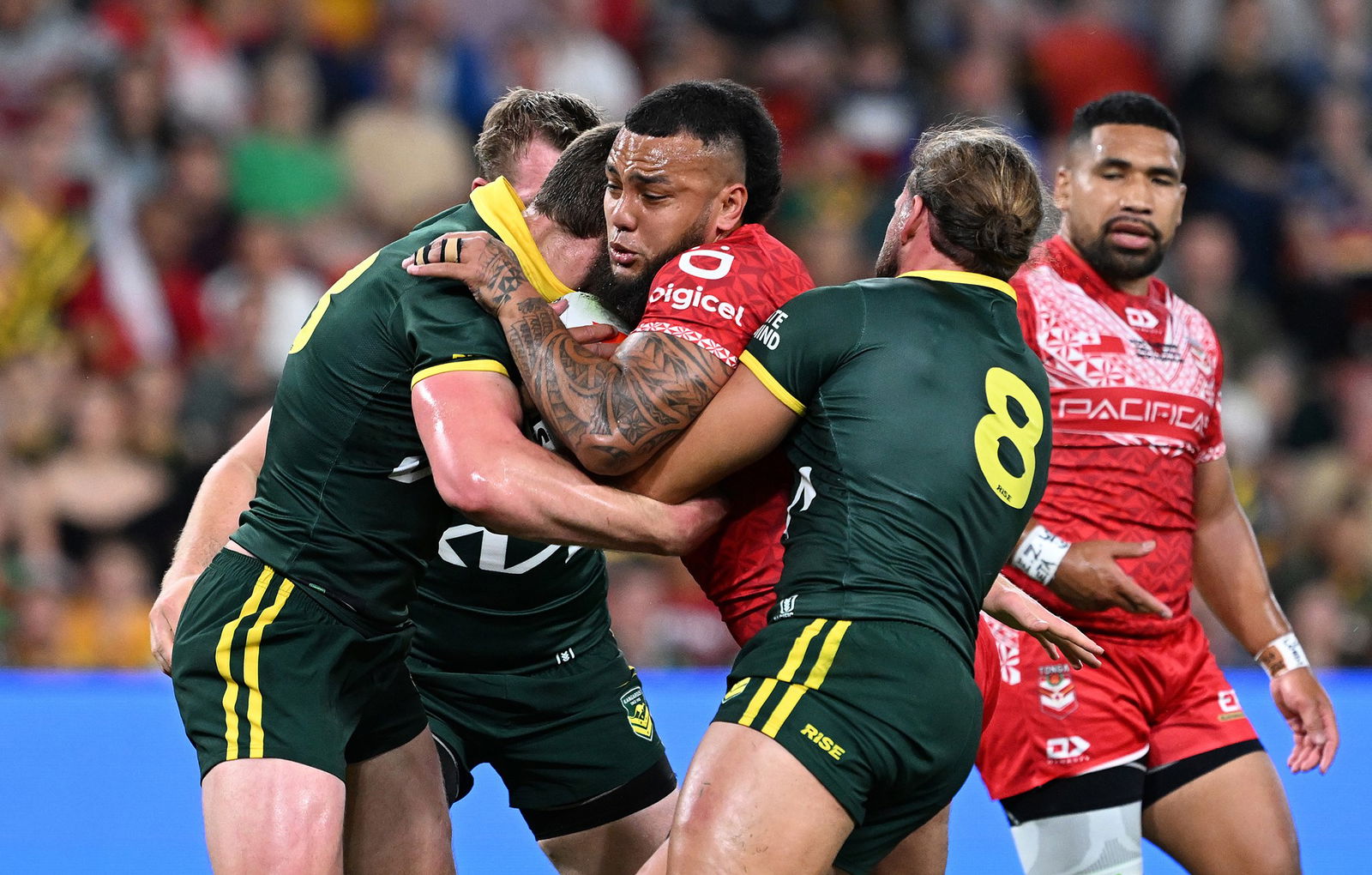 Addin Fonua-Blake runs into Australia's defence.