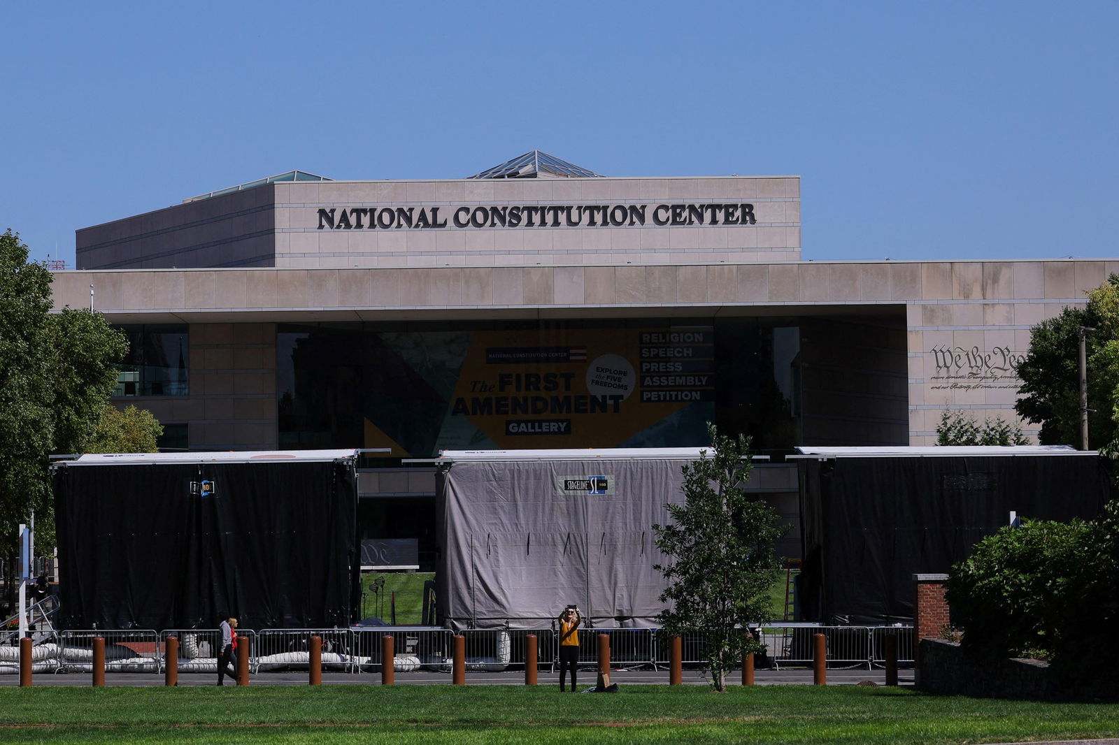 An exterior shot of a large gray building with the National Constitution Center on top 