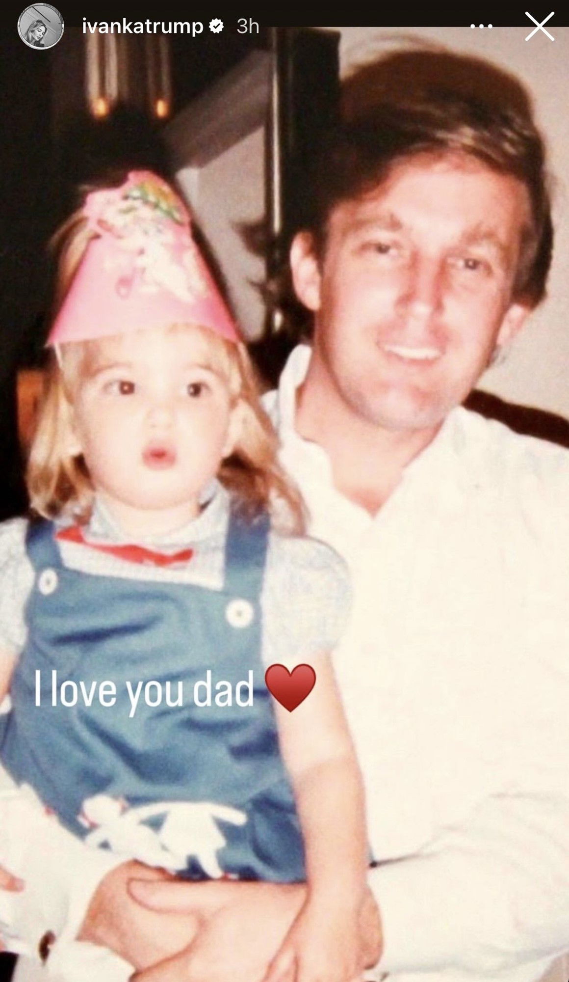 A little girl sitting on her dad's lap.