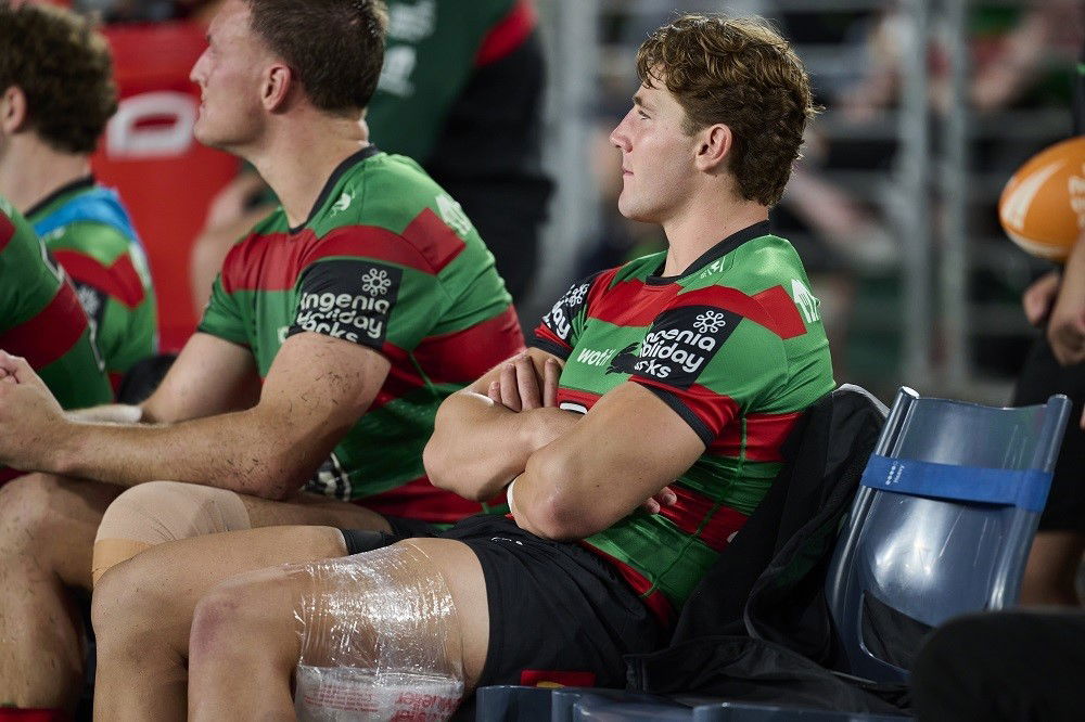 South Sydney player Jamie Humphreys sits on the bench with ice on his hamstring.