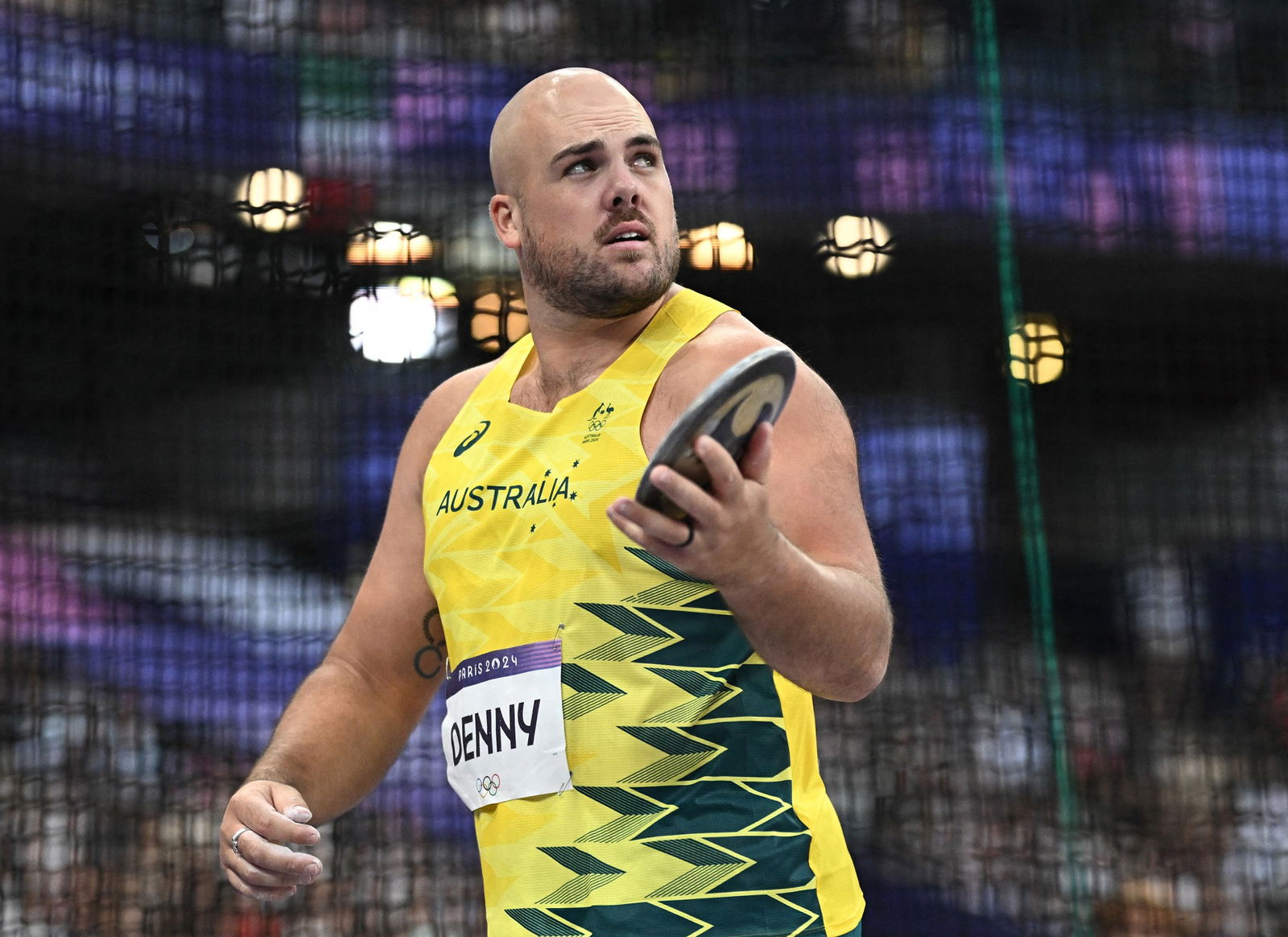 Matthew Denny holds a discus.