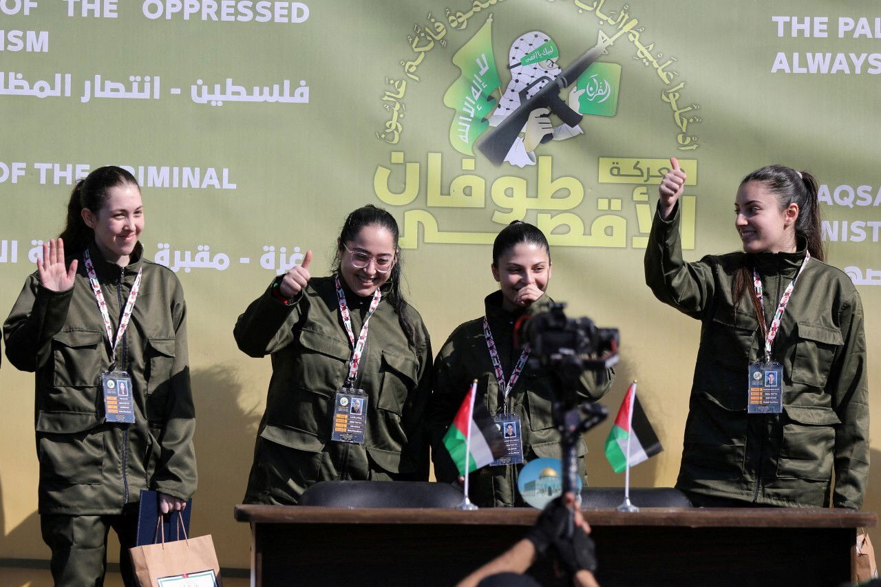 Four women standing on a stage.