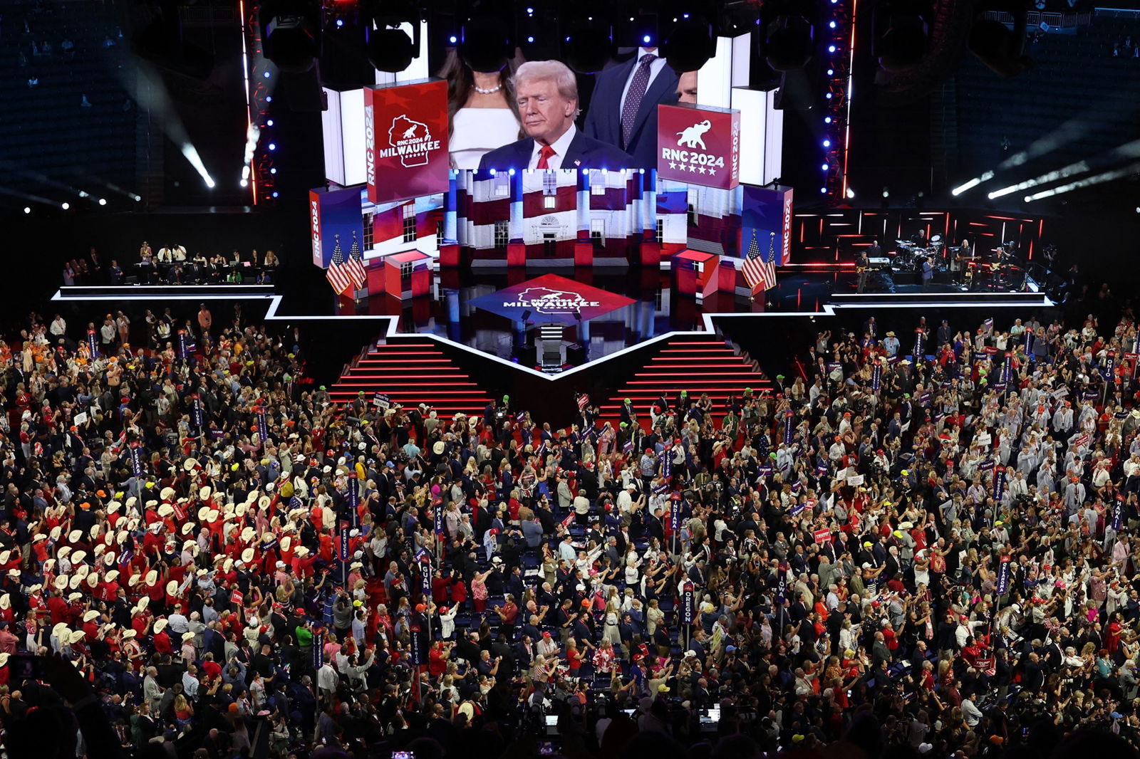 A wide shot of the convention as Trump is shown on the big screen