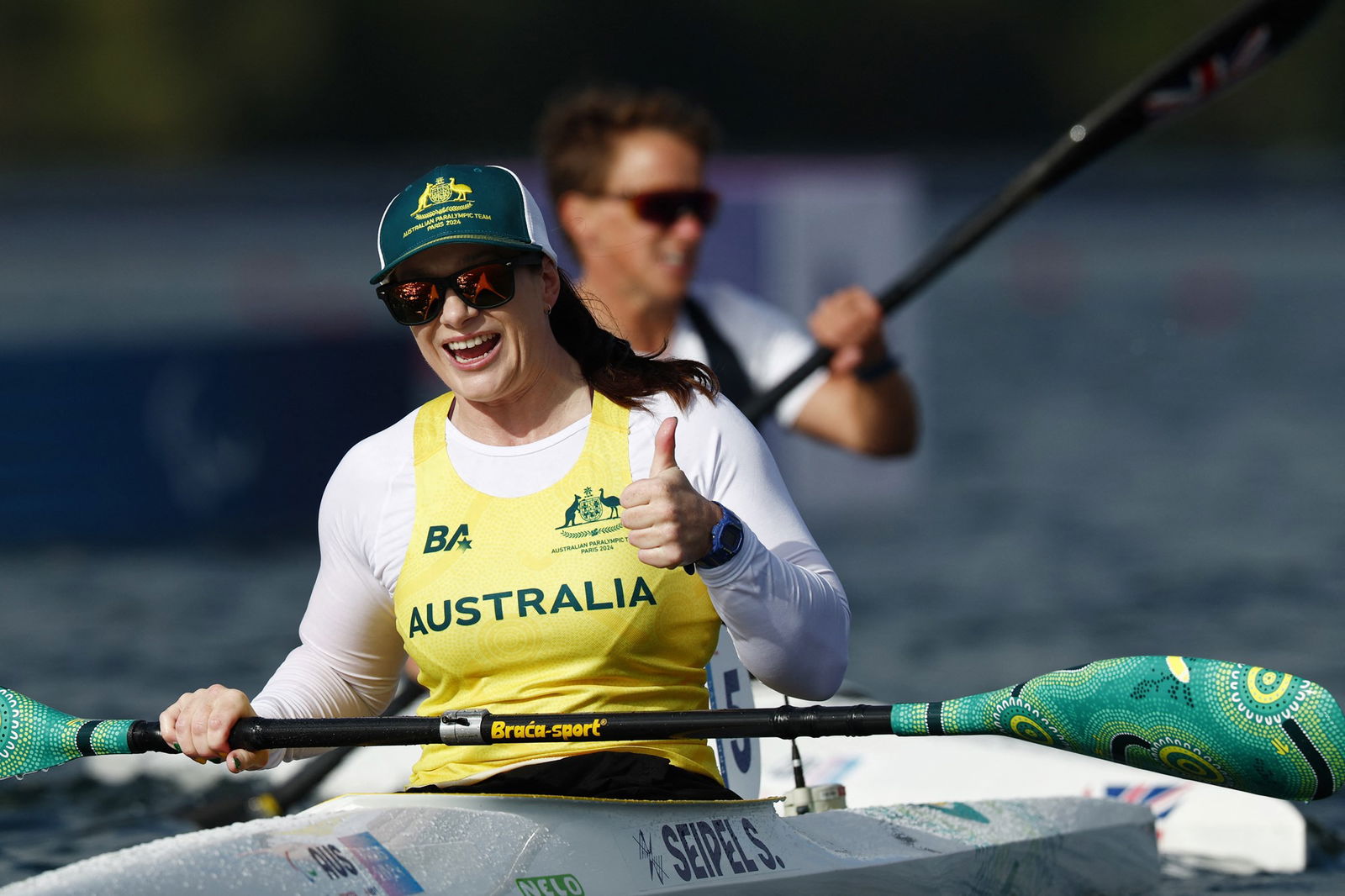 Australian Para canoeist Susan Seipel smiles and gives a thumbs up after winning her semi.