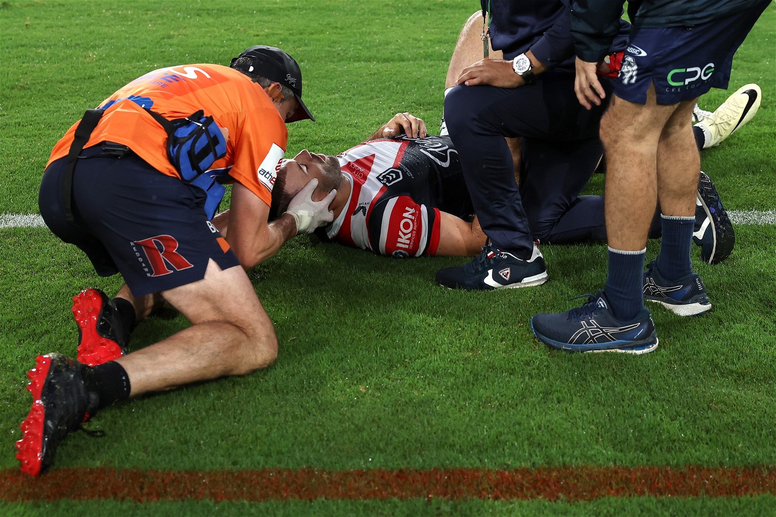 Medical staff examine the Roosters' James Tedesco against the Bulldogs.