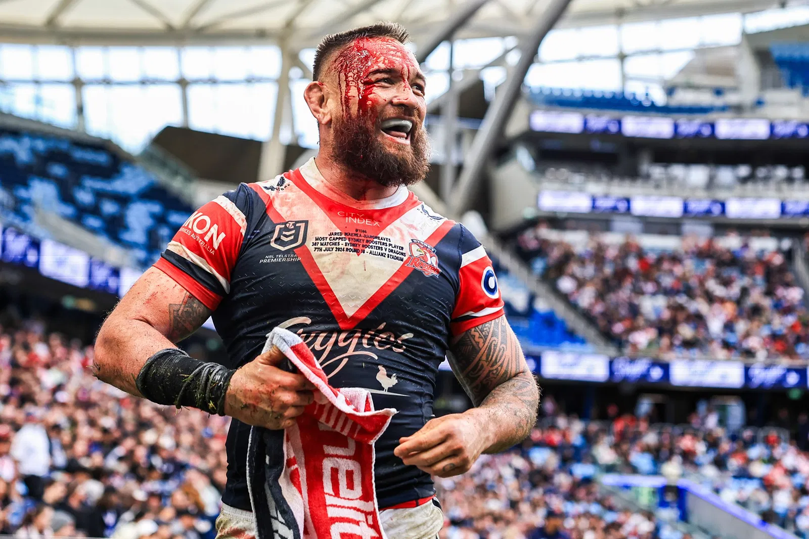 Jared Waerea-Hargreaves smiles while bleeding from the head during a Sydney Roosters NRL game.