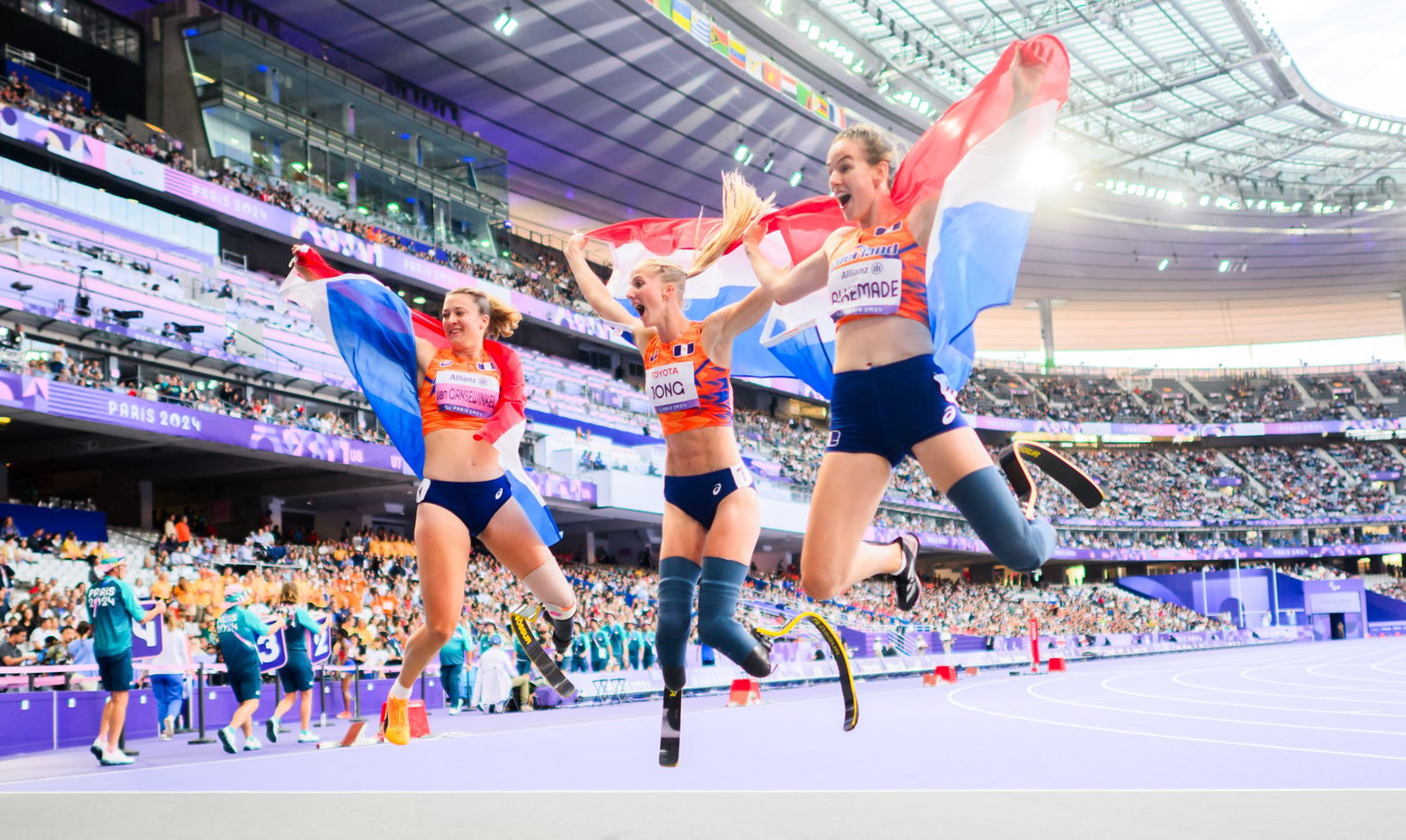 (L to R) Marlene van Gansewinkel, Fleur Jong and Kimberley Alkemade celebrate bronze, gold and silver in the women's 100m T64 final.