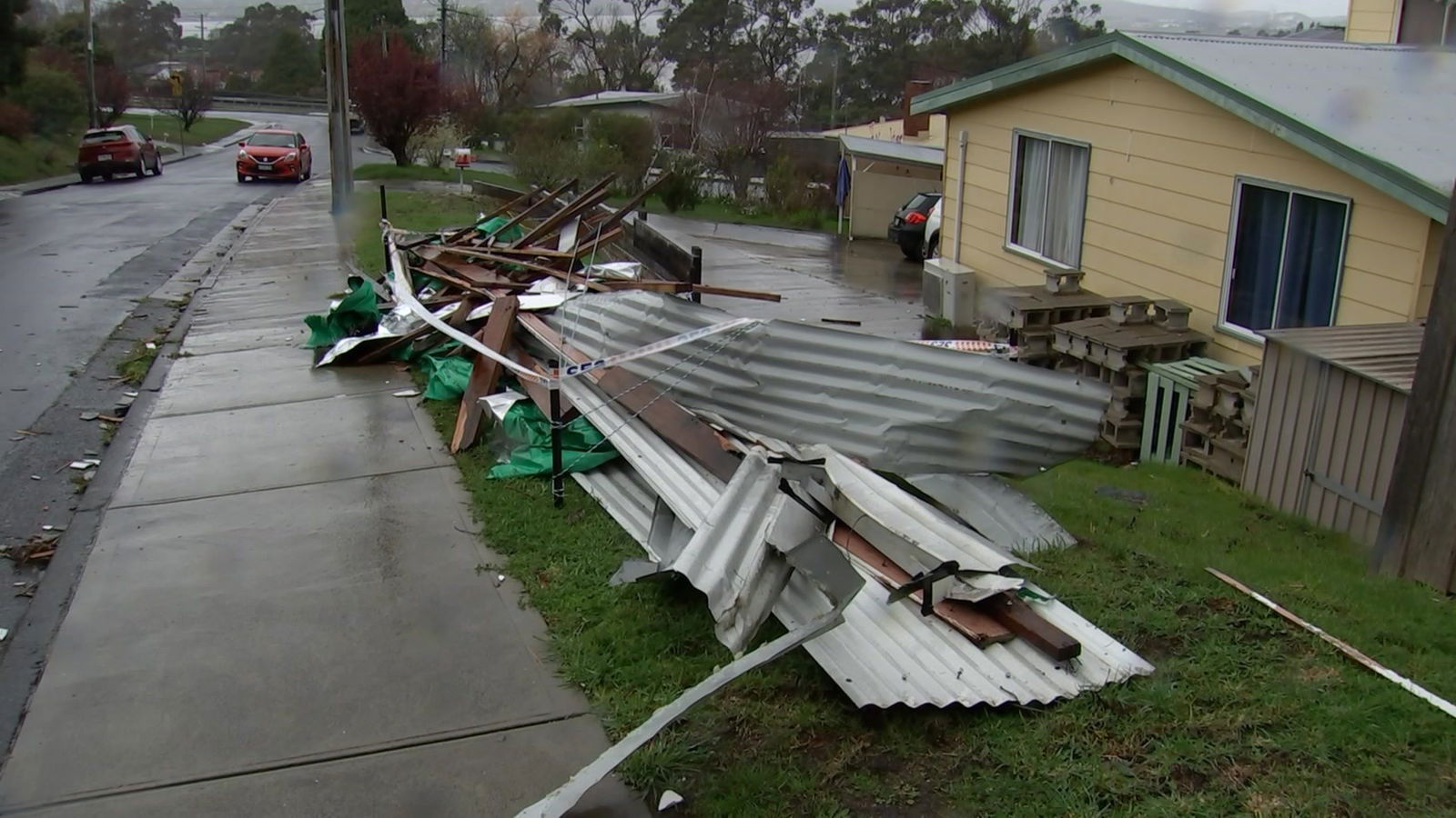 Sheets of metal roofing by the side of a suburban road