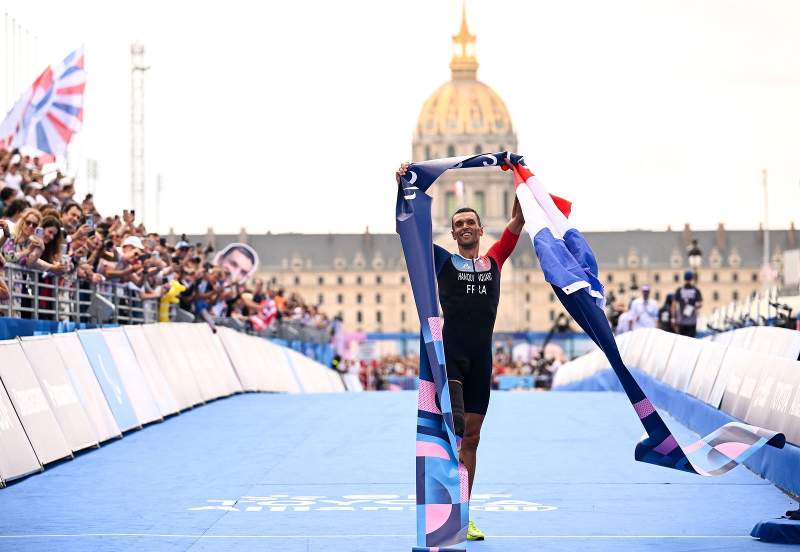 France's Alexis Hanquinquant celebrates at the finish line after winning gold in the men's PTS4 para-triathlon in Paris. 