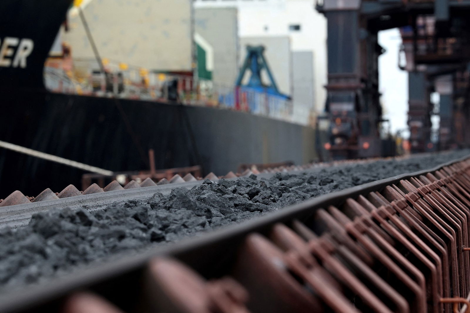 Coking coal is being unloaded on a conveyor belt