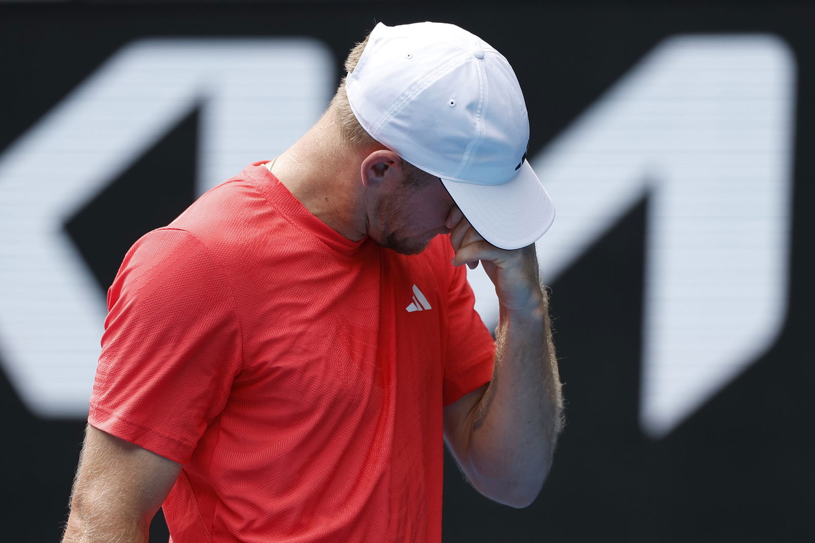 Alejandro Davidovich Fokina puts his hand to his face at the Australian Open.