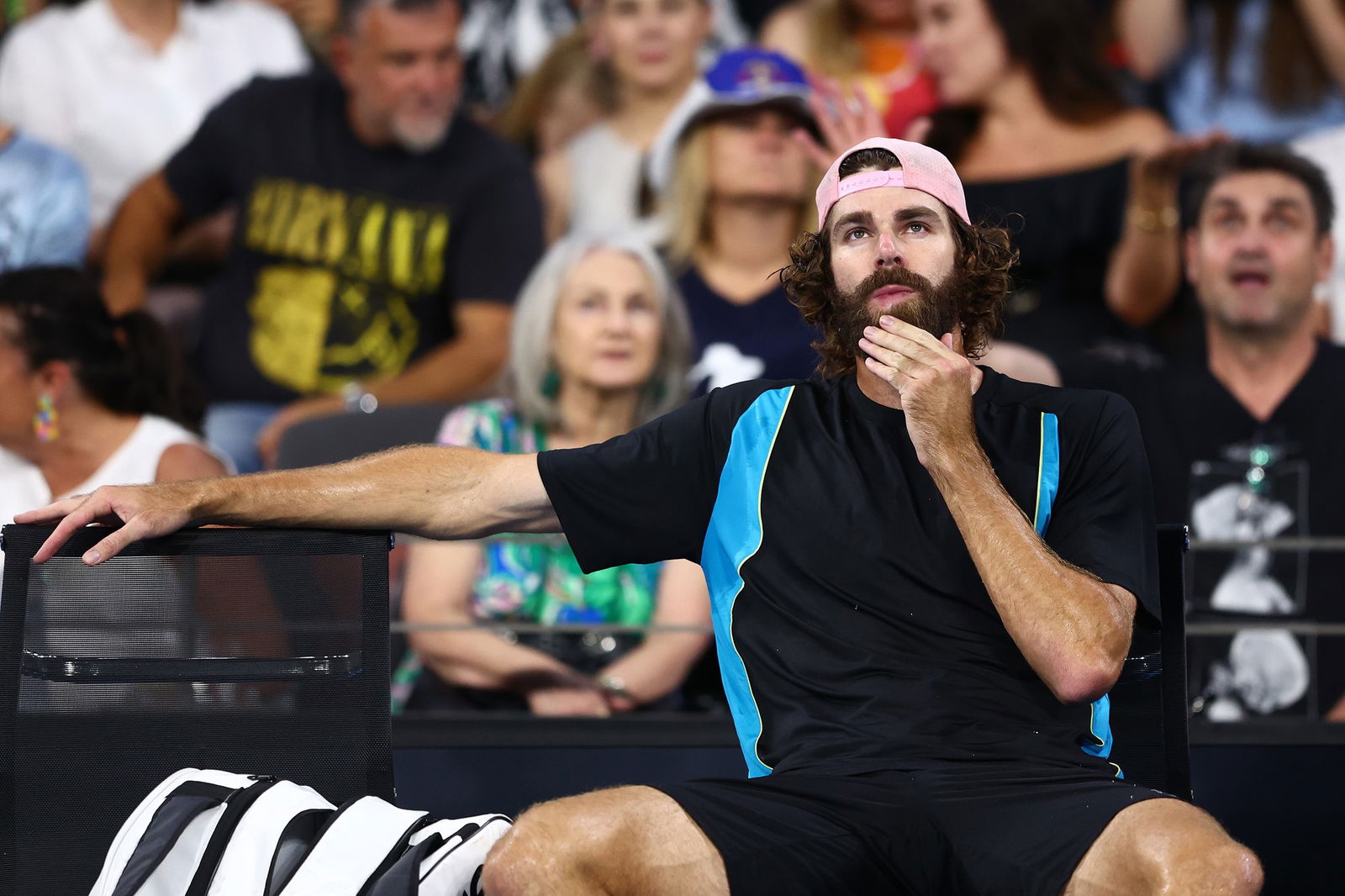 Reilly Opelka sitting in his courtside chair.