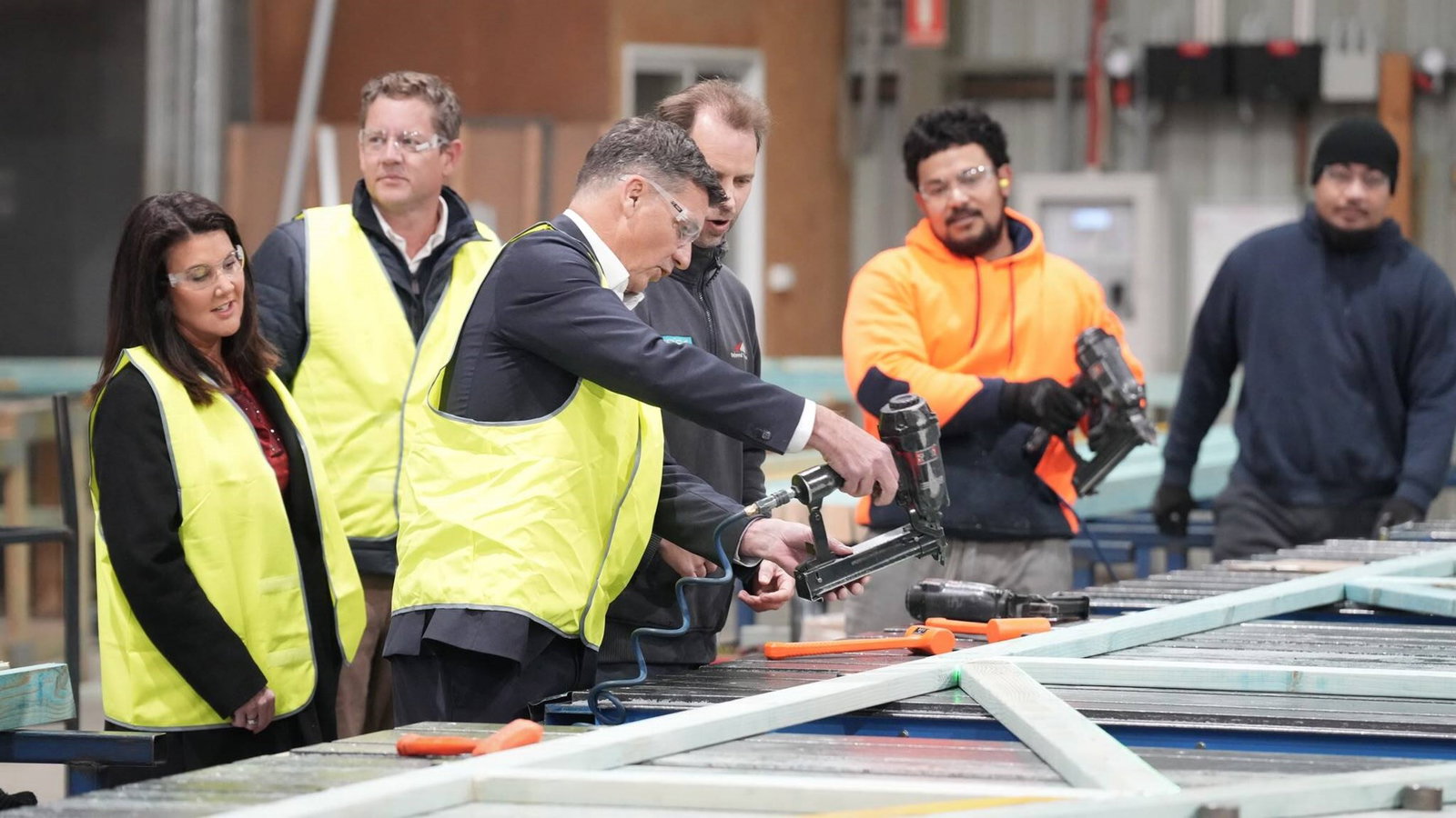 Angus Taylor using an electric hammer.