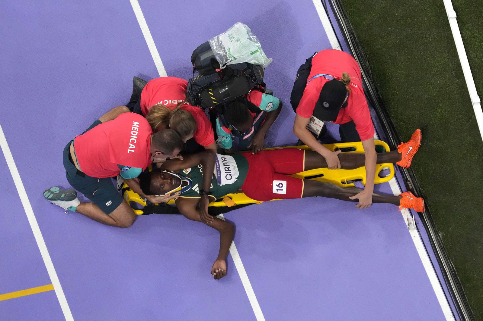 Ethiopia's Lamecha Girma is put on a stretcher after a fall in the men's 3000m steeplechase final.