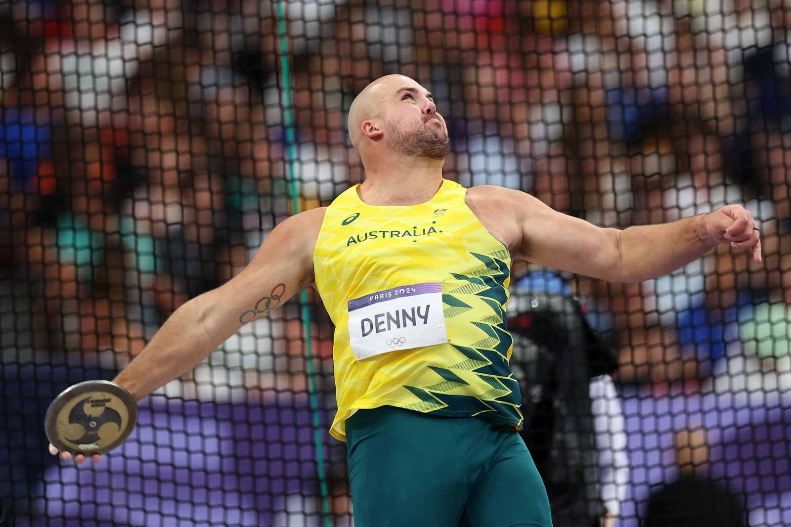 Matthew Denny throws a discus.