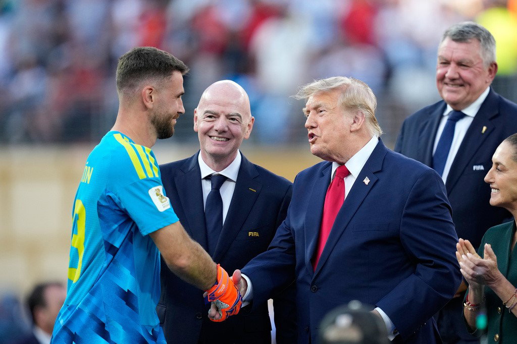 Spain goalkeeper Unai Simon is congratulated by US President Donald Trump.