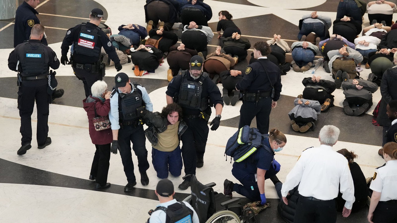 Police usher away protesters.