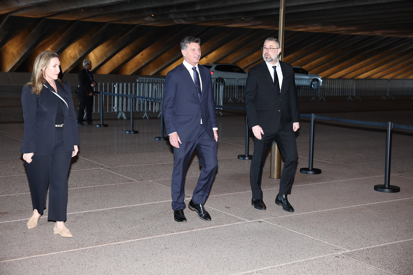 Angus Taylor walking in a suit