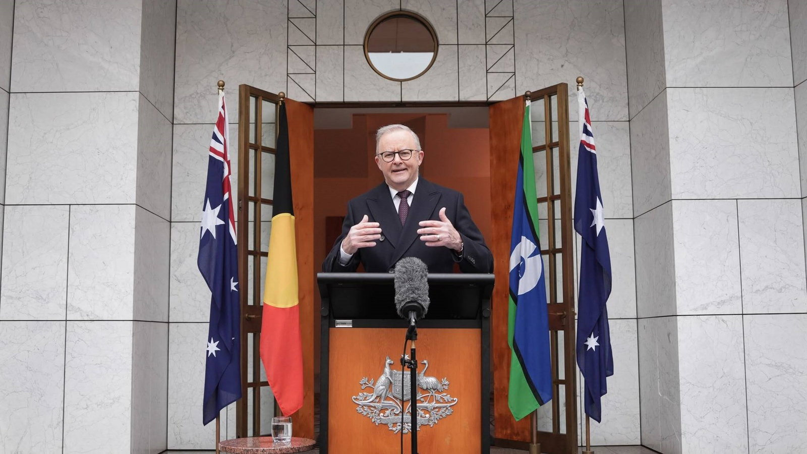 PM gestures as he speaks from the podium.