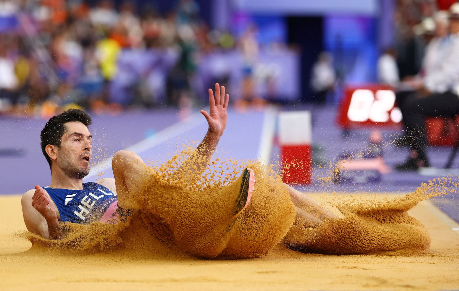 Miltiádis Tentóglou lands in the pit during the men's long jump final.