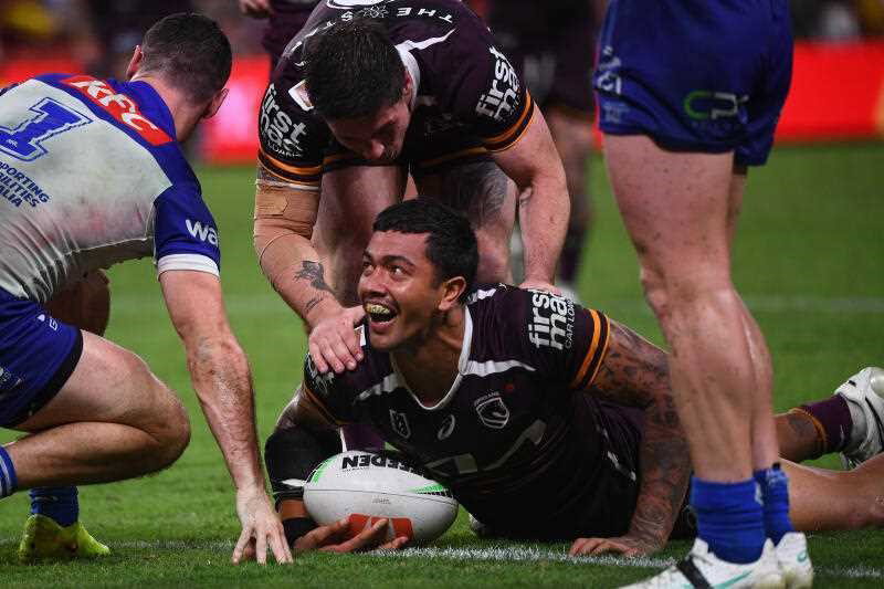 Xavier Willison of the Broncos scores a try