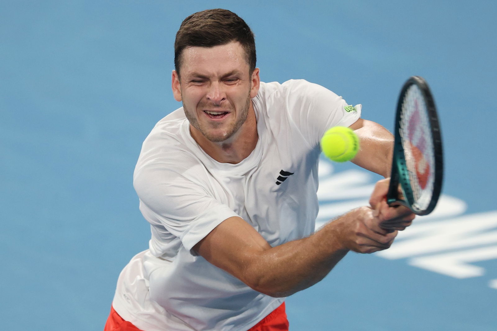 Hubert Hurkacz stretches for a backhand.