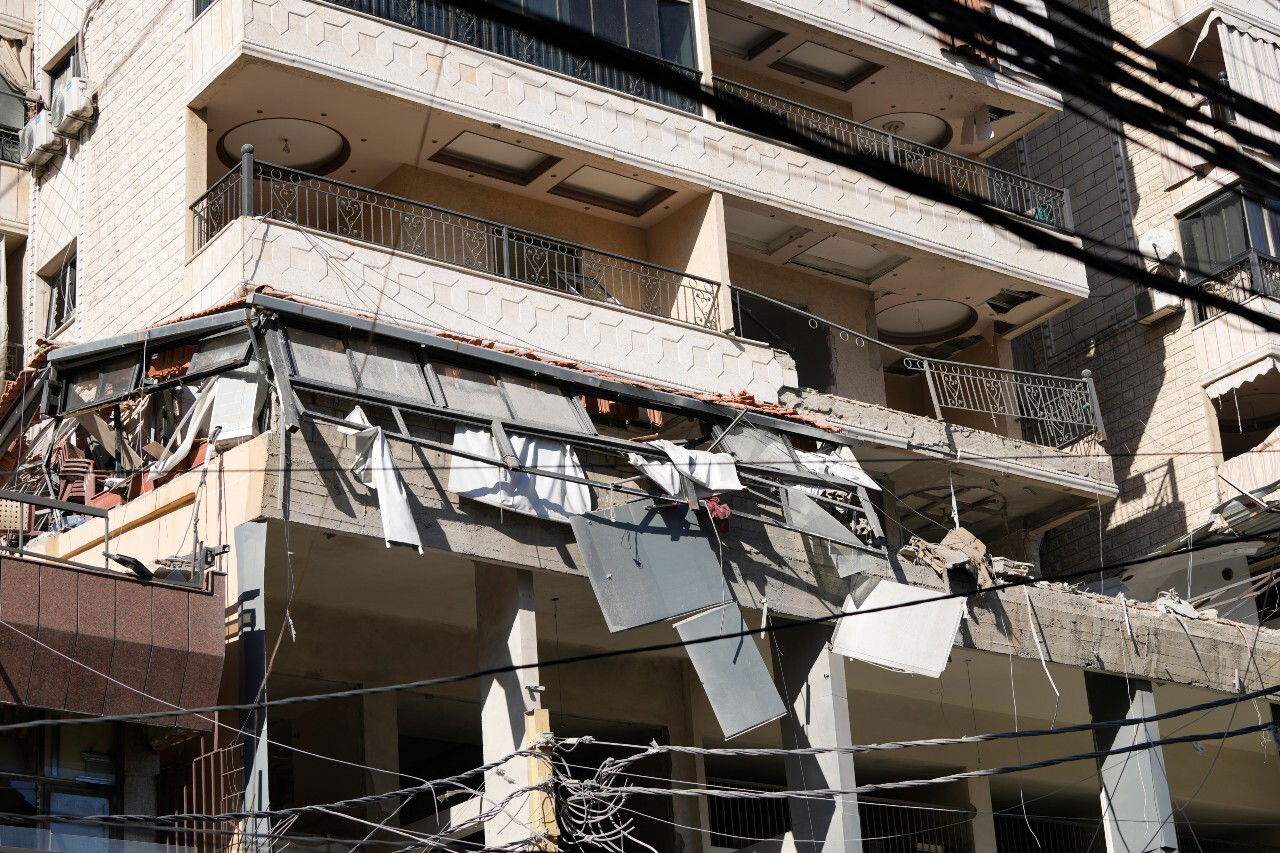 Damage to a building, seen from across the street.