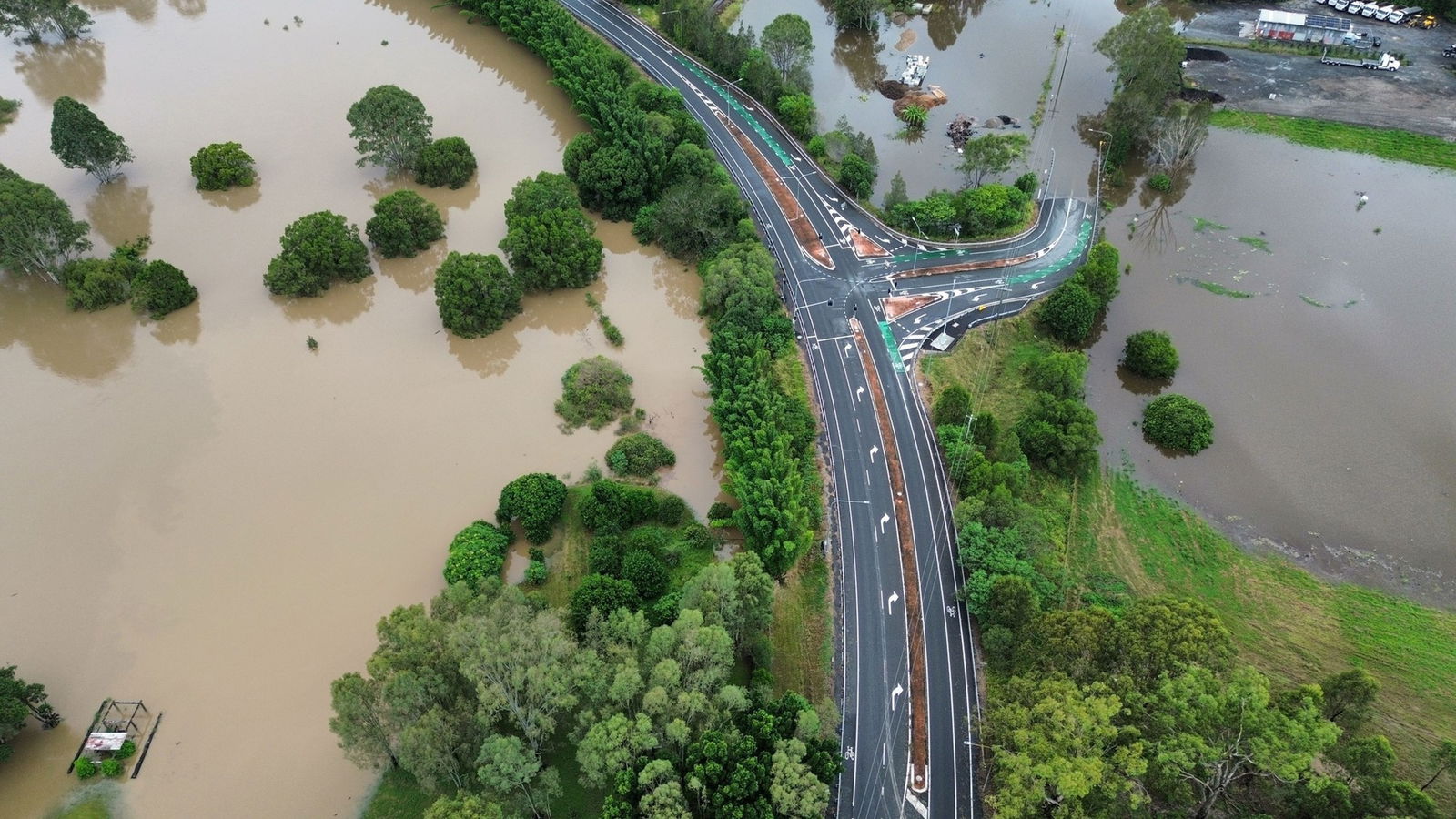 An aerial shot of a highway with flooding on the left and right