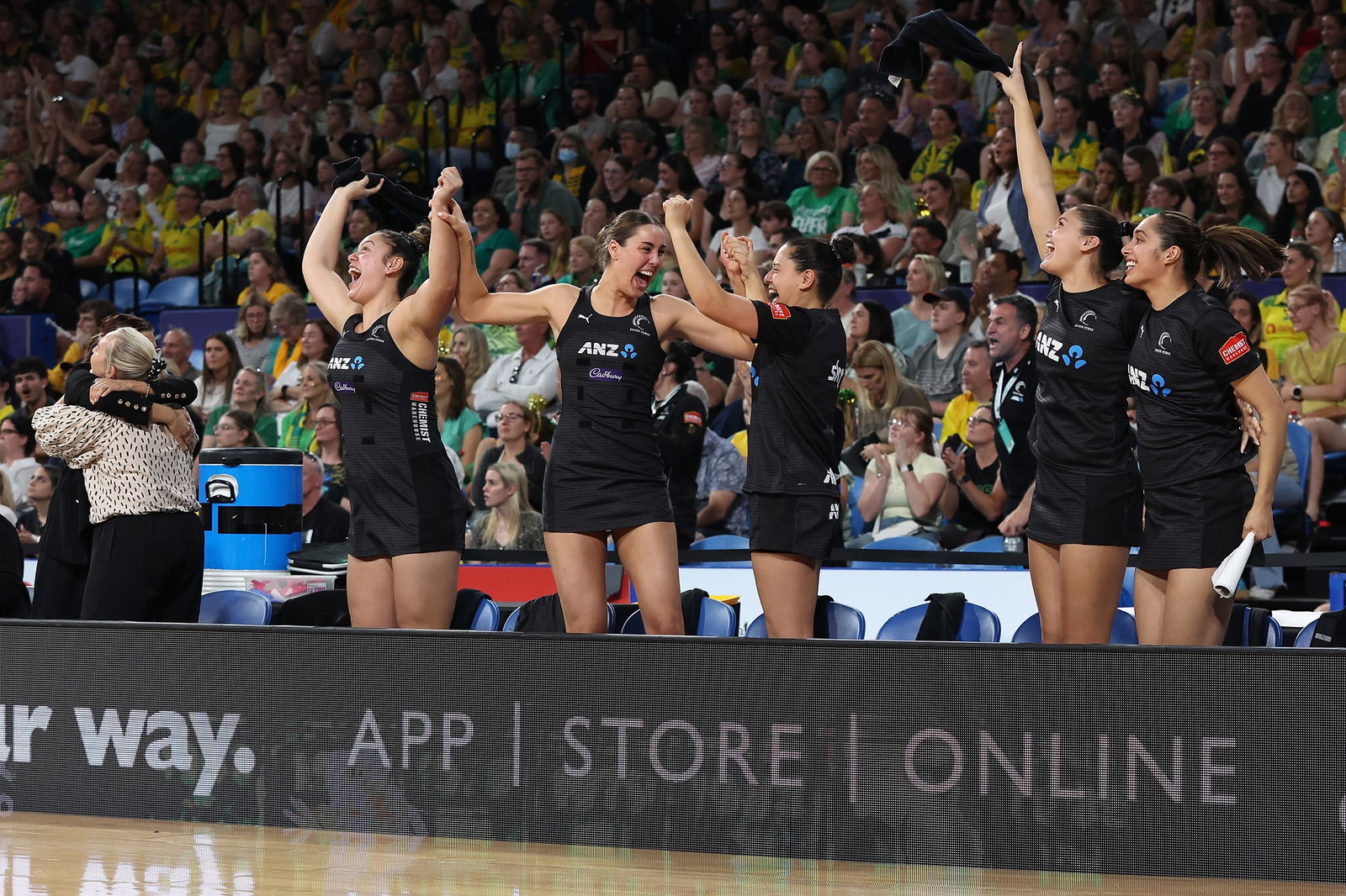 Players stand up on the bench and cheer