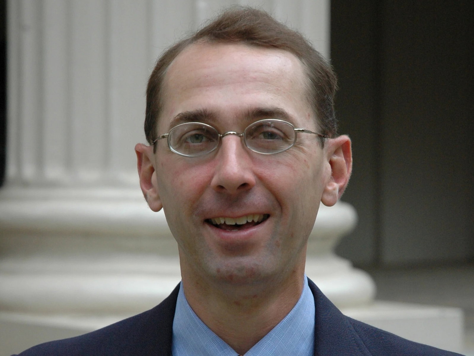 A close-up shot a man with glasses