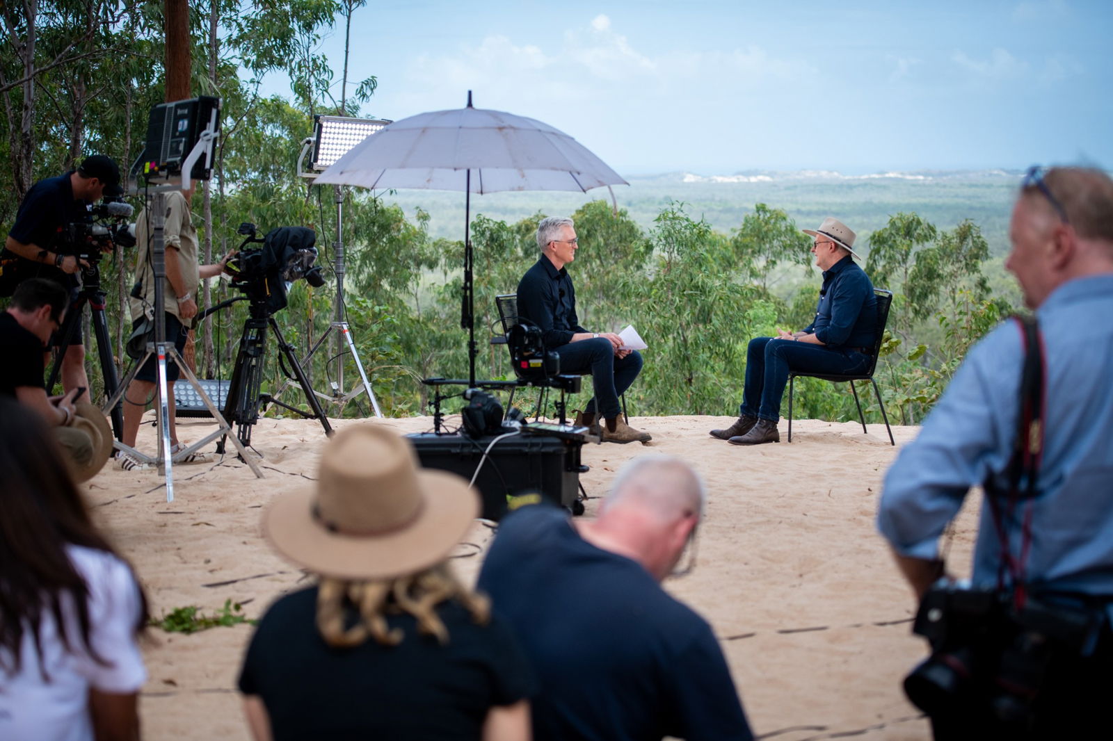A TV interview set with the PM and David Speers, overlooking a bush vista.