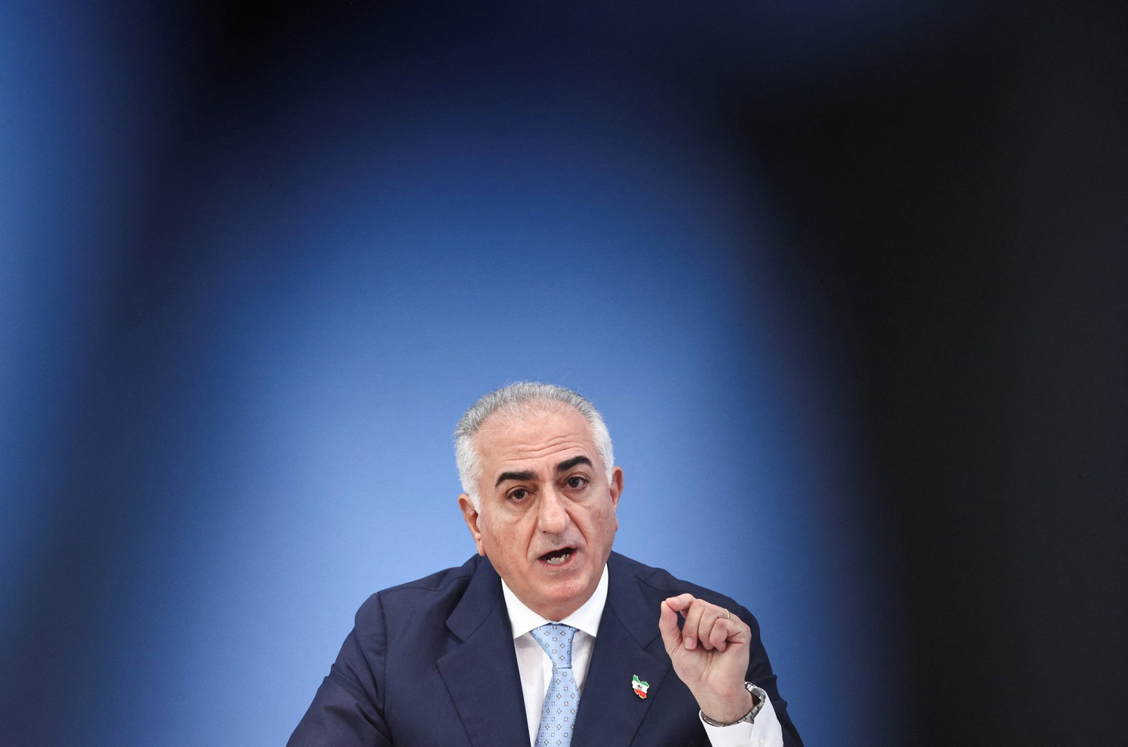 A man in a suit with a vignette lens circling him.