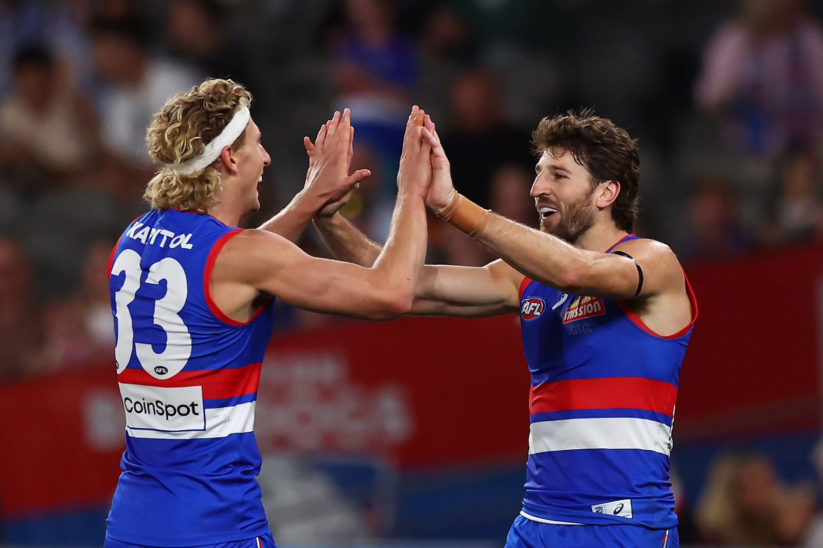 Aaron Naughton and Marcus Bontempelli high five.