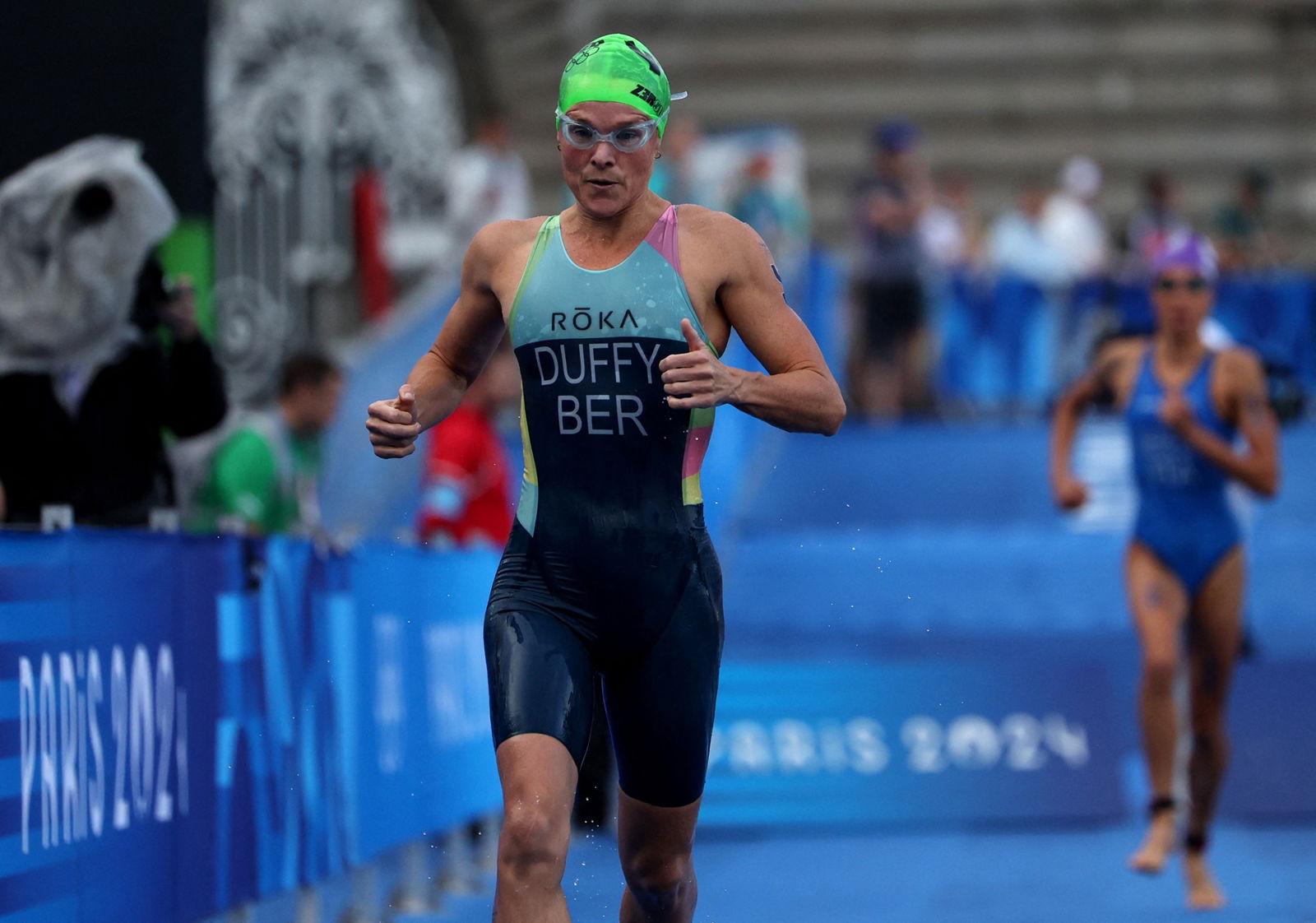 Flora Duffy runs between the two triathlon swim legs