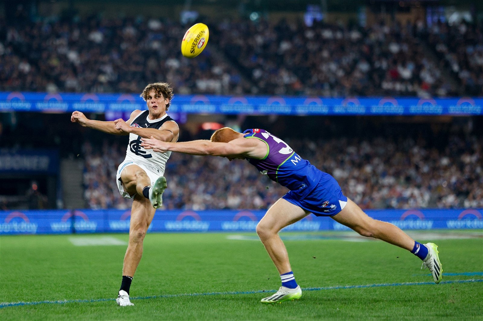 Carlton's Charlie Curnow kicks the ball against North Melbourne at Docklands.