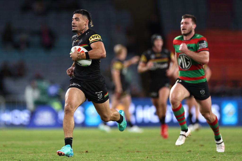 Penrith Panthers' Taylan May runs away from South Sydney's Jai Arrow to score a try in an NRL game.