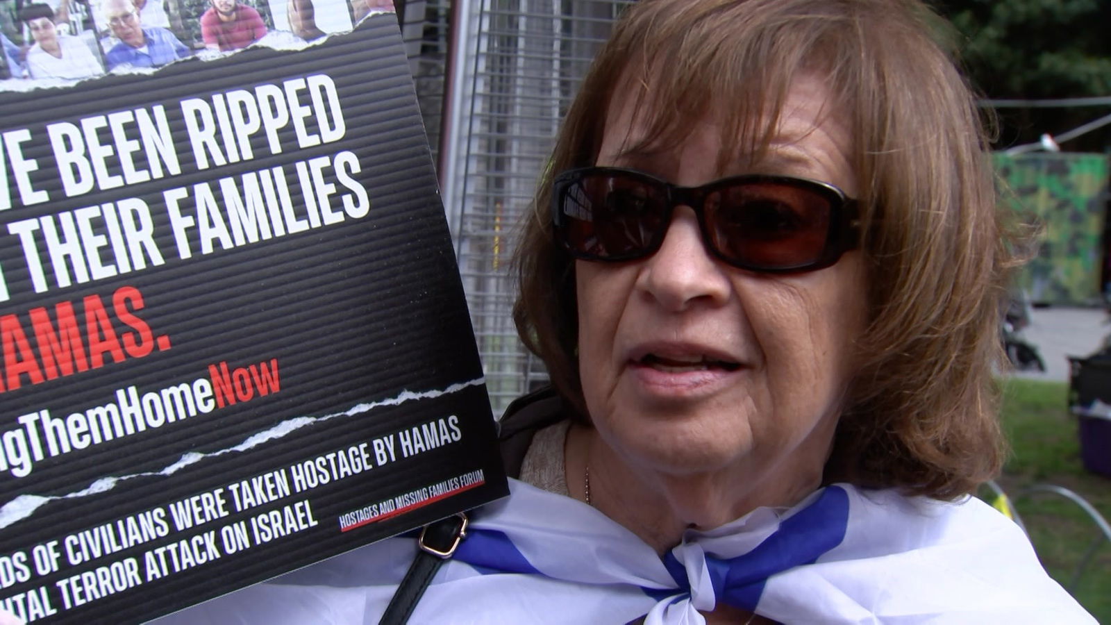 A woman holding a placard