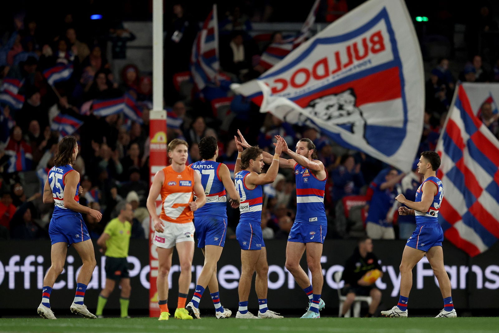 Lachie McNeil is congratulated by the Bulldogs for his goal against GWS, at Docklands on July 31, 2025.